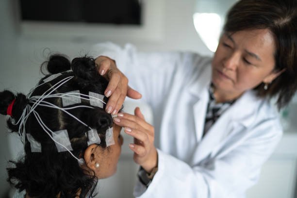 Doctor placing electrodes on patient's head for a medical exam