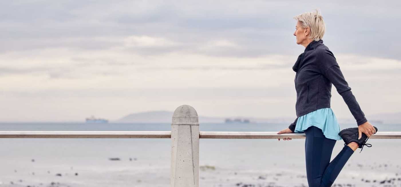Senior women doing fitness and stretching at the beach