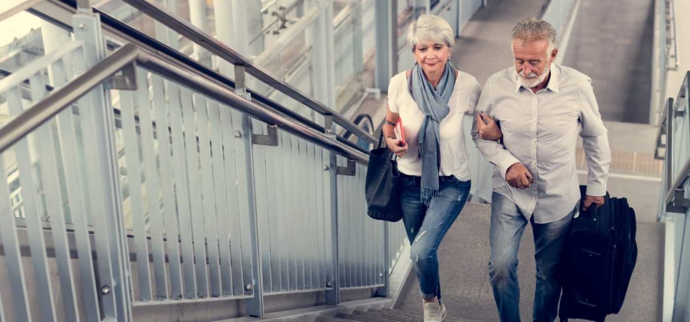 elderly couple traveling together 