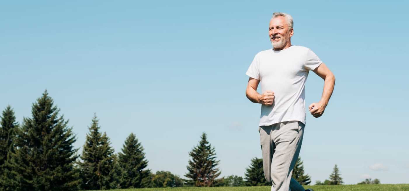 A smiling old age man jogging